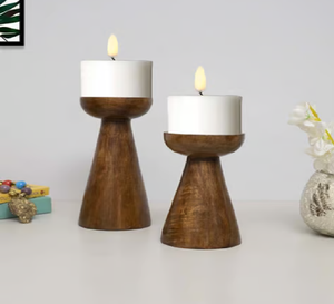 A distressed <b>white</b>, elaborately turned wooden <b>candle</b> holder prominently displays a single <b>white</b> <b>pillar</b> <b>candle</b> - Product Image 3