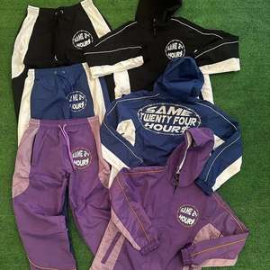 Venta al por mayor nuevo chándal personalizado de nailon chándal con cremallera traje cortavientos chaqueta con cremallera conjunto con capucha 100% conjunto corto de nailon - Product Image 1