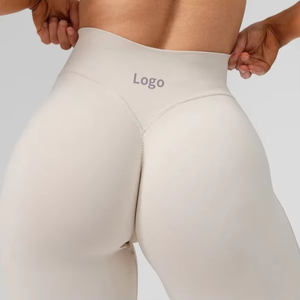 Pantalones de yoga OEM con logotipo personalizado Las mallas de entrenamiento de gimnasio de cintura alta brillantes más vendidas para mujeres Bolsillos de patrón sólido Ropa de fitness - Product Image 3