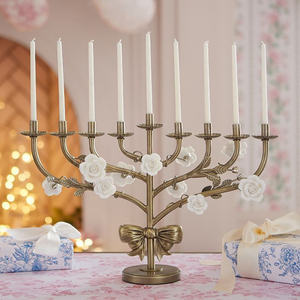 "Charming antique finish menorah with <b>white</b> porcelain roses and a decorative bow detail, great for gifting, at wholesale price." - Product Image 1