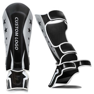 Espinilleras de Piel para Artes Marciales Mixtas (MMA), Kickboxing, Muay Thai, con Cierre de Velcro, Protección y Absorción de Impactos, Color Blanco y Negro, Nuevo - Product Image 1