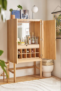 High leg light oak <b>wooden</b> bar cabinet with <b>slatted</b> mirror back and wine storage, available at wholesale prices. - Product Image 1