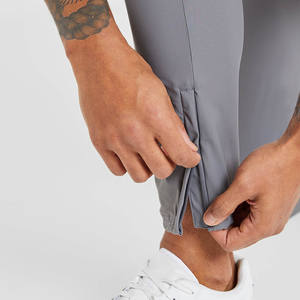 Joggers de tela elástica transpirables ajustados grises de alta calidad para hombre para cintura elástica de hombre y detalles de cremallera en el puño - Product Image 3