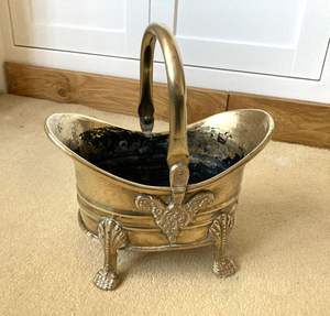Antique hand hammered brass <b>coal</b> bucket for storing <b>coal</b> beside traditional open fireplace in rustic country home interiors - Product Image 1