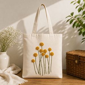 Sac fourre-tout en coton brodé Golden Bloom avec pompon pour femme, grand sac à main tendance pour un usage quotidien - Product Image 1