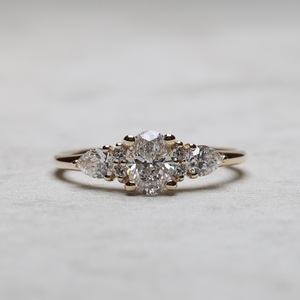 8x6mm Oval Cut Moissanite Engagement Ring with Pear Side <b>Stones</b> | Elegant Bridal Wedding Jewelry - Product Image 1