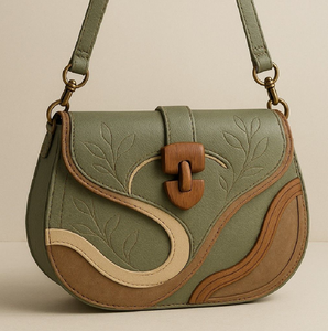 Sage green saddle bag with unique wood clasp and leaf embossing. Earthy style. Available at wholesale prices. - Product Image 1