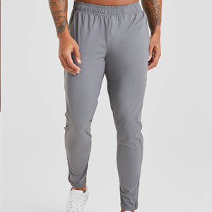 Joggers de tela elástica transpirables ajustados grises de alta calidad para hombre para cintura elástica de hombre y detalles de cremallera en el puño - Product Image 1