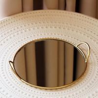 Plateau miroir rond luxueux avec cadre métallique chic, parfait pour la décoration des fêtes, les mariages ou les événements.