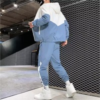Ensemble survêtement deux pièces en polyester avec veste coupe-vent zippée en nylon et pantalon de jogging patchwork, collection hiver 2026