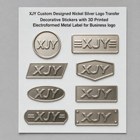 Autocollants en métal électroformé 3D personnalisés en nickel argenté XJY pour l'image de marque et l'emballage des entreprises