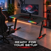 Bureau de jeu noir avec plateau nervuré, accents RGB à l'avant et pieds rouges pour bureaux à domicile, salles d'étude et salles de jeu
