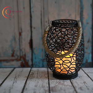 Introducing the Sophisticated Black Metal Lantern Featuring an Intricate Swirling Pattern That Creates a Lacy Design - Product Image 4