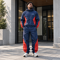 Ensemble survêtement homme personnalisé OEM, veste coupe-vent et pantalon de sport imperméables en polyester et nylon imprimé réfléchissant pour activités de plein air