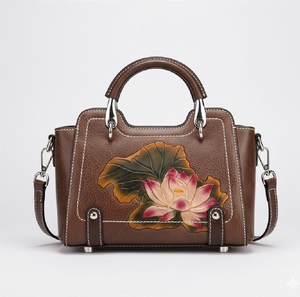 Classic brown leather <b>tote</b> featuring a beautiful hand-<b>tooled</b> pink lotus bloom. Available at wholesale prices. - Product Image 1