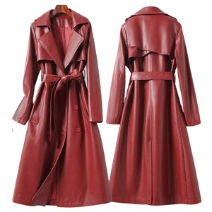 double-breasted leather trench coat in a wine <b>red</b> color, featuring a belted waist and notched - Product Image 1