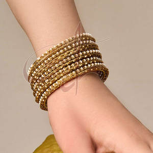 Ideal Balance Simplicity And Elegance Combination Of Gold Bangles And One Distinctive Beaded Bangle - Product Image 1