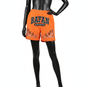 Shorts cortavientos para mujer, tela de nailon premium, color naranja sólido, parche bordado de chenilla, pedrería, shorts personalizados para mujer - Product Image 1