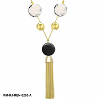 Collier tendance moderne noir et blanc avec pendentif gland doré, long bijou géométrique en résine et laiton pour femme, idéal pour les soirées