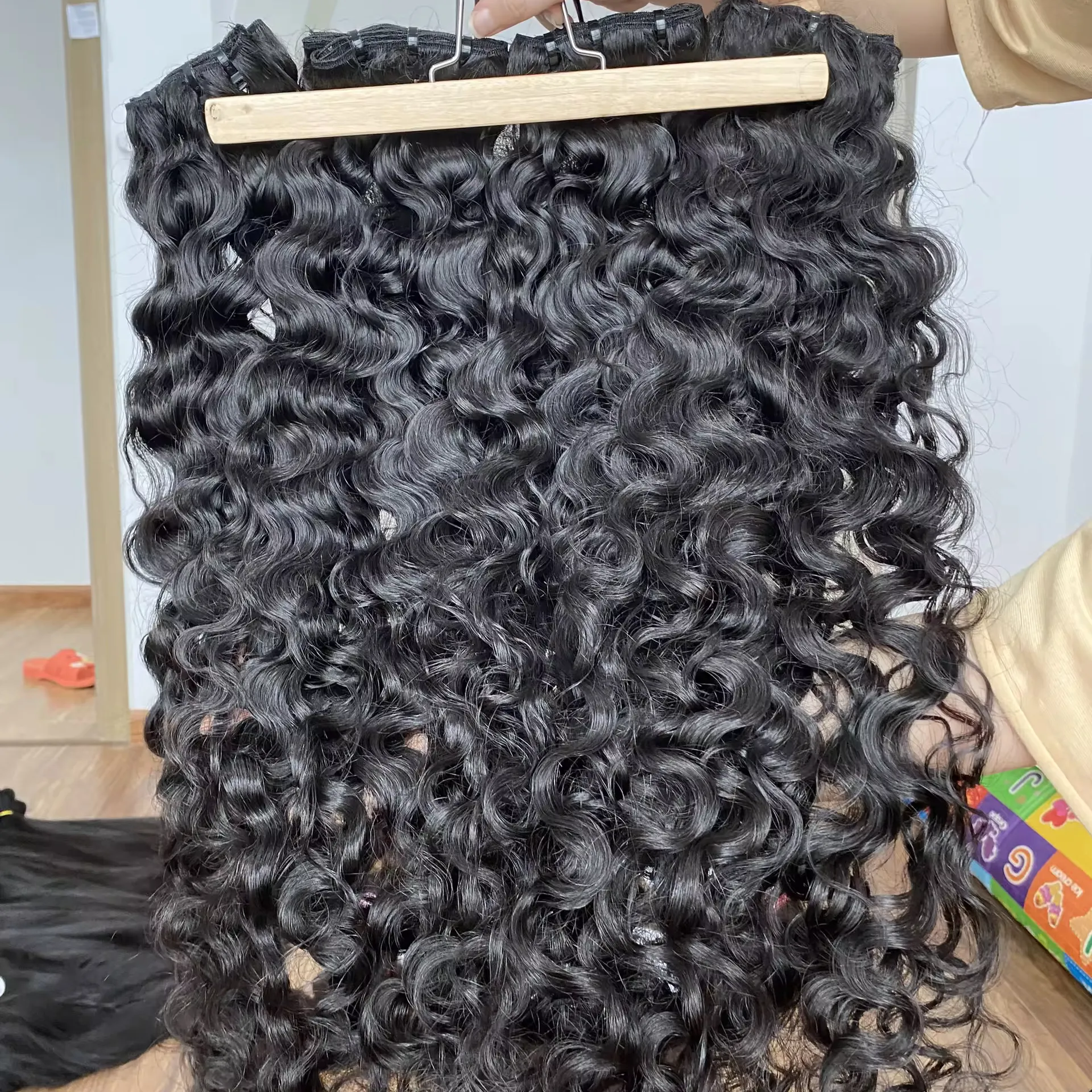 Кудряя текстура, выровненная кутикула, натуральные пряди необработанных бирманских, камбоджийские кудряющиеся необработанные человеческие волосы