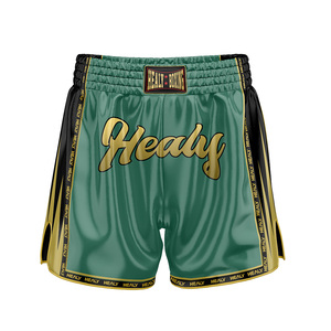 กางเกงชกมวย Healy สำหรับผู้ชาย สีเขียวทอง พิมพ์ลายโลโก้ด้วยเทคนิค Sublimation ผลิตจากโพลีเอสเตอร์ ยืดหยุ่นได้ เหมาะสำหรับศิลปะการต่อสู้ ทรงปกติ สำหรับผู้ใหญ่ - Product Image 1