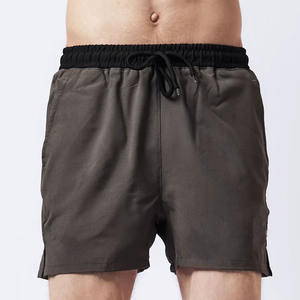 กางเกงขาสั้นผู้ชายผ้าฝ้ายแห้งเร็วแบบมีเชือกผูก สีพื้น สไตล์ลำลอง รับทำโลโก้ OEM - Product Image 1