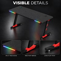 Bureau de jeu noir avec plateau nervuré, accents RGB à l'avant et pieds rouges pour bureaux à domicile, salles d'étude et salles de jeu