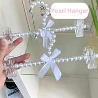 Cintres à pantalons en perles avec pinces et joli nœud en ruban