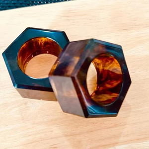 Handcrafted resin napkin rings with glossy finished and intricate carving design for luxurious festive table styling - Product Image 1