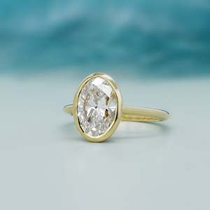 Oval Engagement <b>Ring</b> in Yellow Gold with Bezel Set <b>Diamond</b> Elegant <b>Diamond</b> <b>Rings</b> Collection - Product Image 3