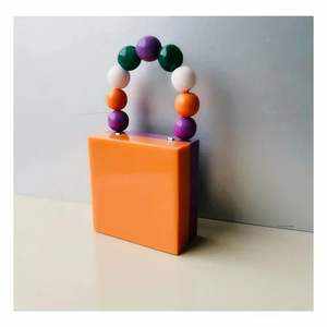 Bestseller resin <b>clutch</b> with glossy pattern handmade by Indian artisans perfect for evening events - Product Image 1