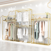 Porte-vêtements de luxe en acier inoxydable doré de haute qualité, support de présentation pour boutique avec base en MDF imitation marbre