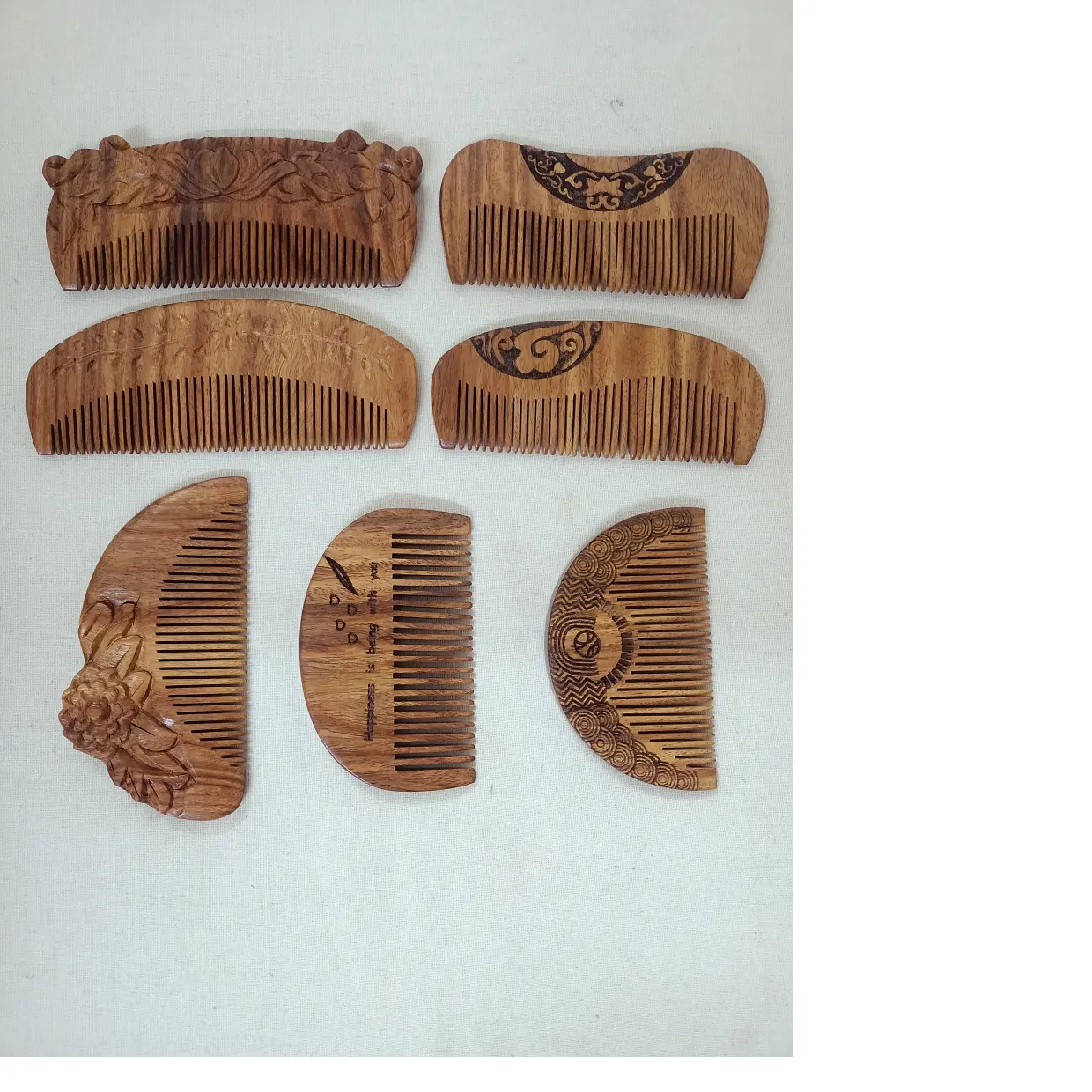 custom made engraved wooden combs in an assortment of sizes and shapes with unique engraved designs ideal for resale