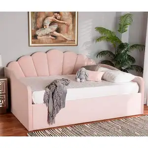 Freda daybed made of solid wood frame and pink velvet fabric with a shell-shaped back.