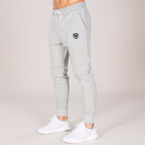 Pantalón ajustado Jogger de hombre con agujeros desgastados de color gris brezo con logotipos personalizados - Product Image 1