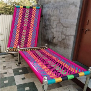 Dos charpais de colores brillantes con tejidos geométricos intrincados en rosa, amarillo y azul sobre patas metálicas, a precios de mayorista. - Product Image 1