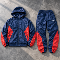 Ensemble survêtement homme personnalisé OEM, veste coupe-vent et pantalon de sport imperméables en polyester et nylon imprimé réfléchissant pour activités de plein air