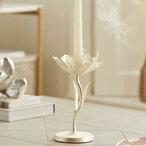 Elegant white <b>flower</b> <b>candle</b> holder with a slender curved stem. Available at wholesale prices. - Product Image 1