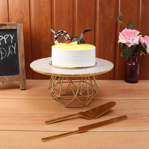 <b>Cake</b> stand featuring a luxurious marble <b>top</b> and a sturdy <b>gold</b>-finished iron wire base perfect for stylish dessert displays. - Product Image 1