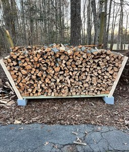 Stacked Hardwood <b>Logs</b> In Metal Rack For Indoor Storage. - Product Image 1