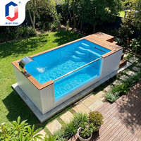 Piscine rectangulaire hors sol avec panneau latéral transparent, terrasse et cascade pour piscine extérieure dans la cour