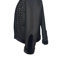 C'est une veste de cérémonie en cuir noir avec garniture en fourrure et boutons argentés, également connue sous le nom de veste hussarde ou dolman.