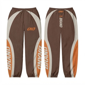 Pantalones Cortavientos Reversibles de Primera Calidad, 110 GSM, 100% Algodón, Cierre con Cordón, Estilo Urbano, Color Marrón con Paneles Curvos Naranja - Product Image 1