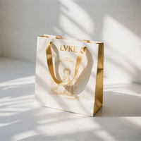 Sac en papier d'aluminium de platine avec poignée en ruban d'or haut de gamme personnalisé sac de shopping d'emballage de bijoux pour femmes