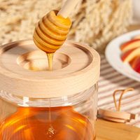 Venta caliente tarro de miel soporte de contenedor de vidrio con tapa de acacia de madera y cucharón tarro de almacenamiento de alimentos de vidrio de alta calidad con tapa
