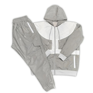 Pantalon coupe-vent personnalisé en polyester superposé Survêtement en nylon pour hommes Ensemble de survêtement deux pièces avec fermeture éclair Vestes coupe-vent pour hommes - Product Image 1