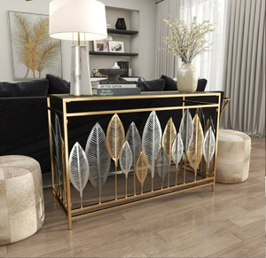 Table console dorée avec feuilles métalliques décoratives, plateau noir, chic, élégant, design contemporain. Disponible aux tarifs de gros. - Product Image 1