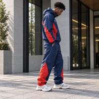 Ensemble survêtement homme personnalisé OEM, veste coupe-vent et pantalon de sport imperméables en polyester et nylon imprimé réfléchissant pour activités de plein air