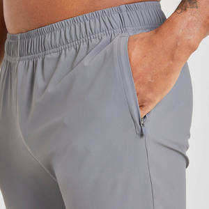Joggers de tela elástica transpirables ajustados grises de alta calidad para hombre para cintura elástica de hombre y detalles de cremallera en el puño - Product Image 2