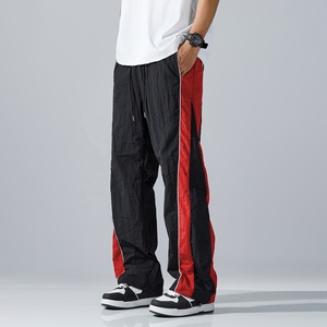 Pantalon de survêtement élégant pour homme, coupe ample et large, avec empiècements contrastants noir et blanc, taille à cordon de serrage, confortable pour le quotidien - Product Image 1